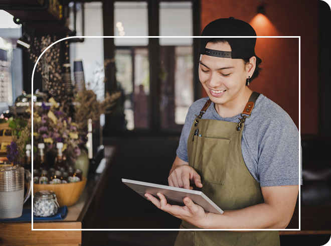 Small business or coffee shop worker taking an order on a tablet